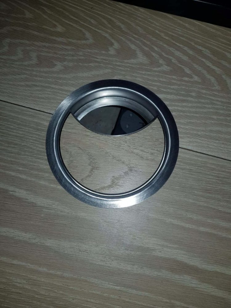 close up of access grommet within wooden table
